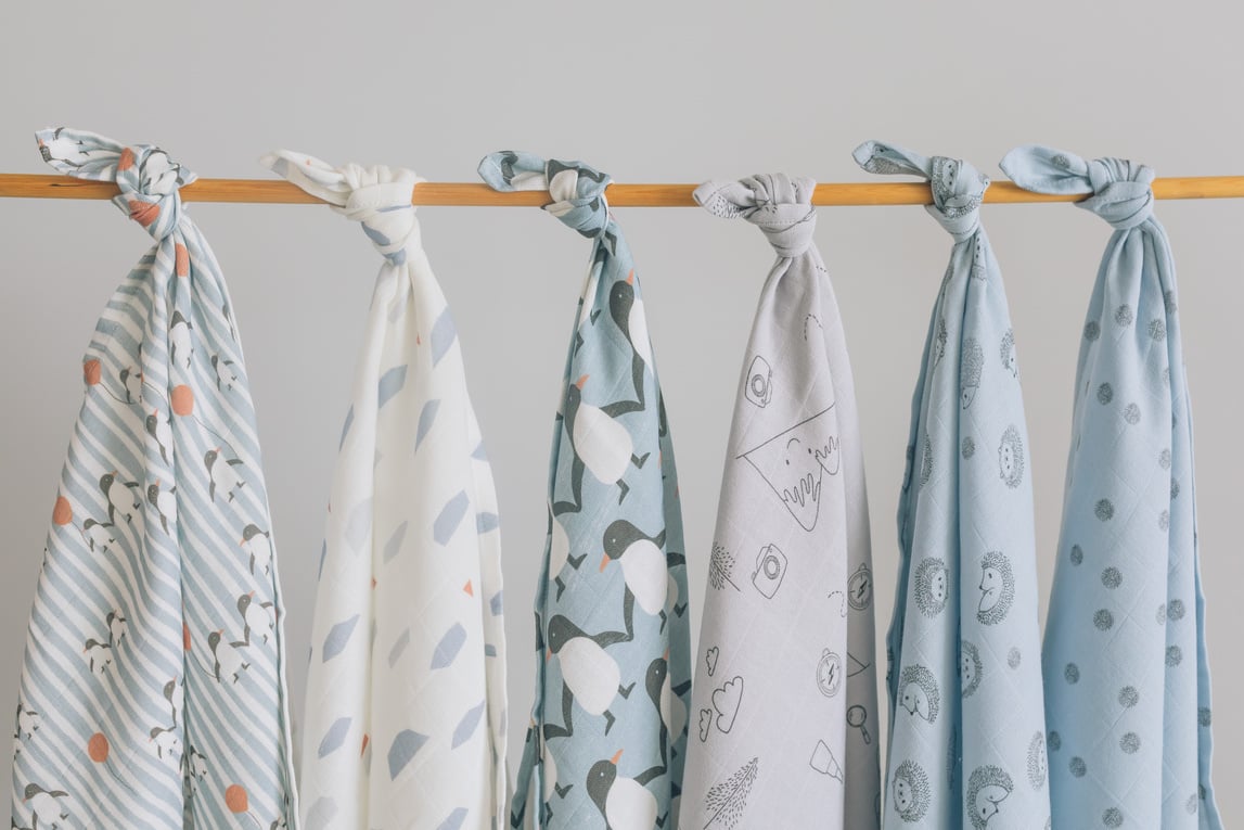 Baby blankets hanging on rack